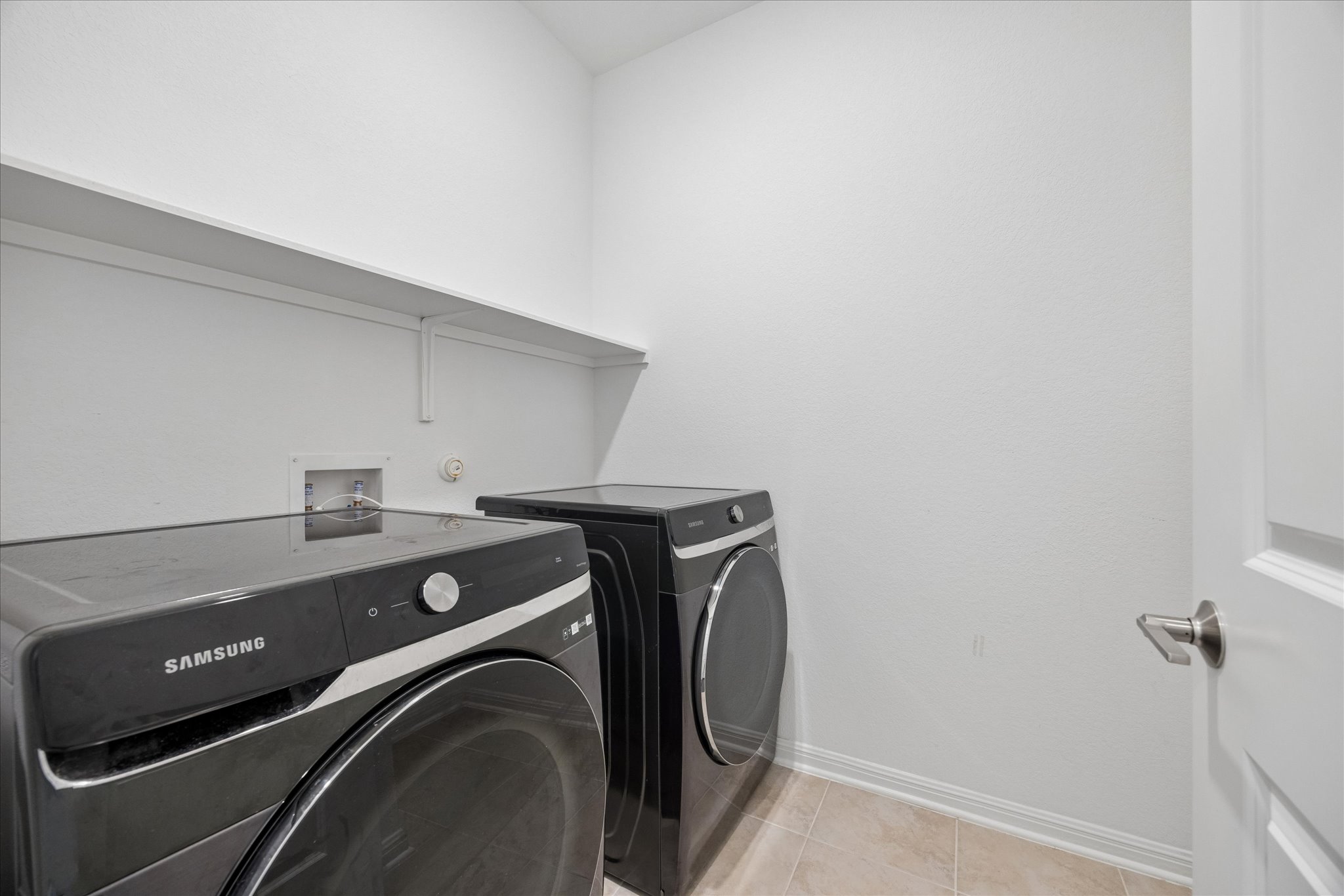 6407 Rounded Pebble Lane Buda, TX 78610 - Photo 27 of 32 A dedicated laundry space provides practical, convenient, and efficient utility.