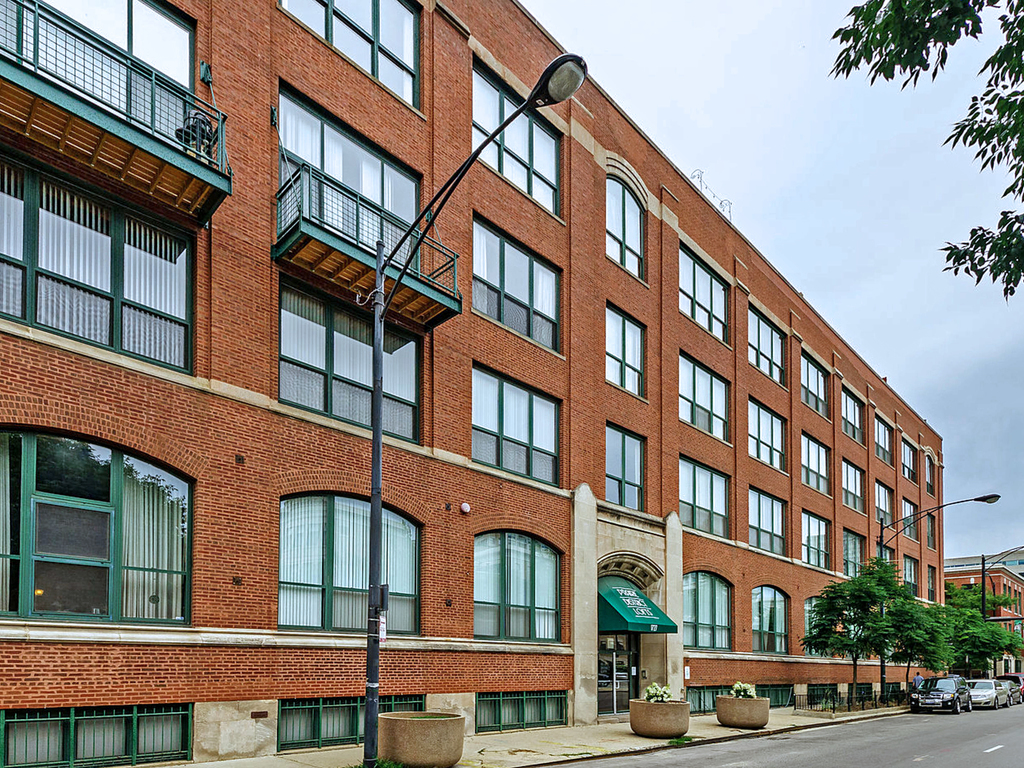 1727 South Indiana Avenue, Unit 324 Chicago, IL 60616 - Photo 1 of 35 a front view of a building with lot of cars and trees
