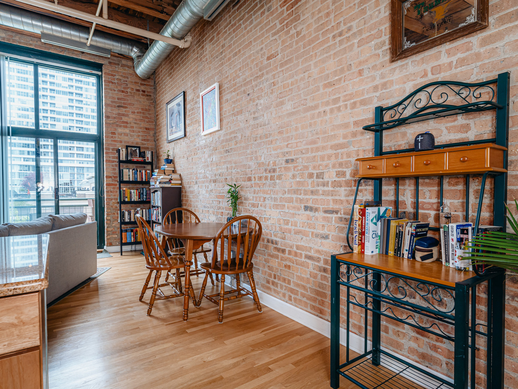 1727 South Indiana Avenue, Unit 324 Chicago, IL 60616 - Photo 11 of 35 a view of a dining room with furniture and wooden floor