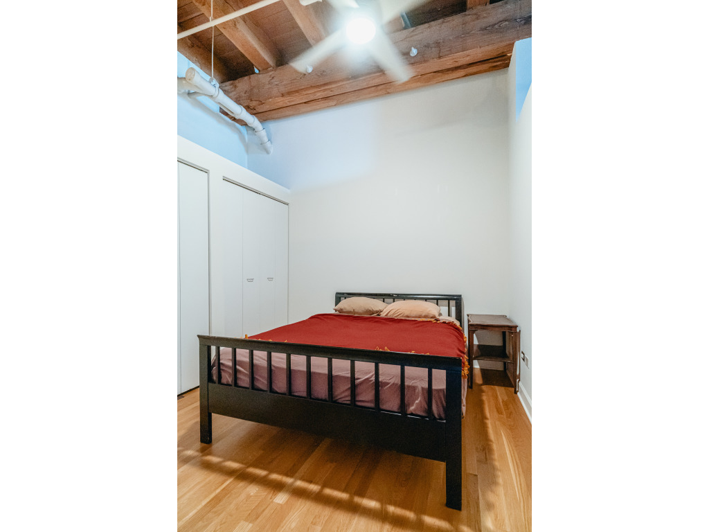 1727 South Indiana Avenue, Unit 324 Chicago, IL 60616 - Photo 13 of 35 a bedroom with a bed and a wall painting
