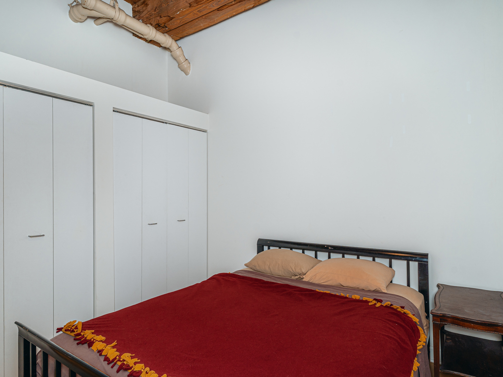 1727 South Indiana Avenue, Unit 324 Chicago, IL 60616 - Photo 14 of 35 a bed sitting in a bedroom next to a window