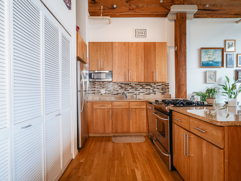 1727 South Indiana Avenue, Unit 324 Chicago, IL 60616 - Photo 10 of 35 a kitchen with stainless steel appliances granite countertop a stove a sink and a refrigerator