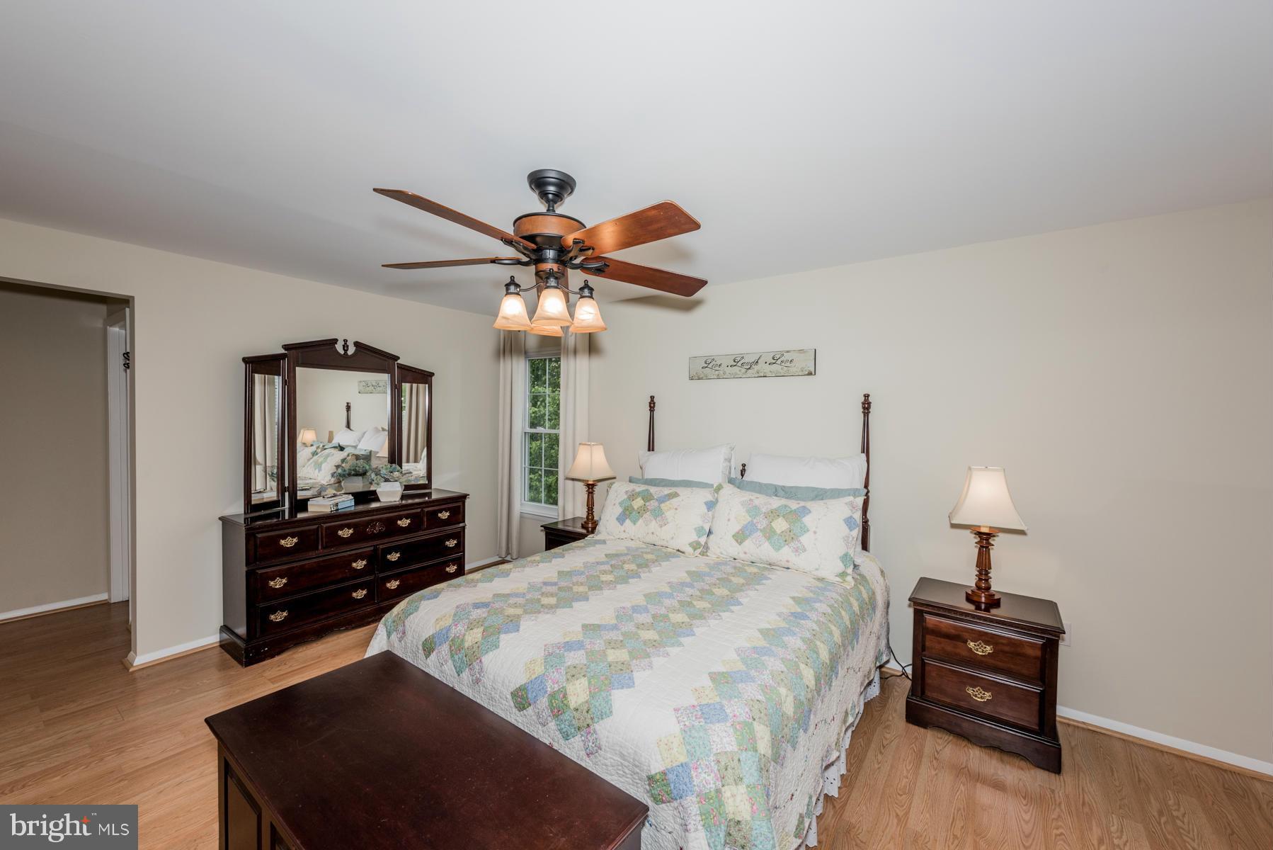 6032 Bakers Place Hanover, MD 21076 - Photo 17 of 30 a bedroom with a bed and a chandelier