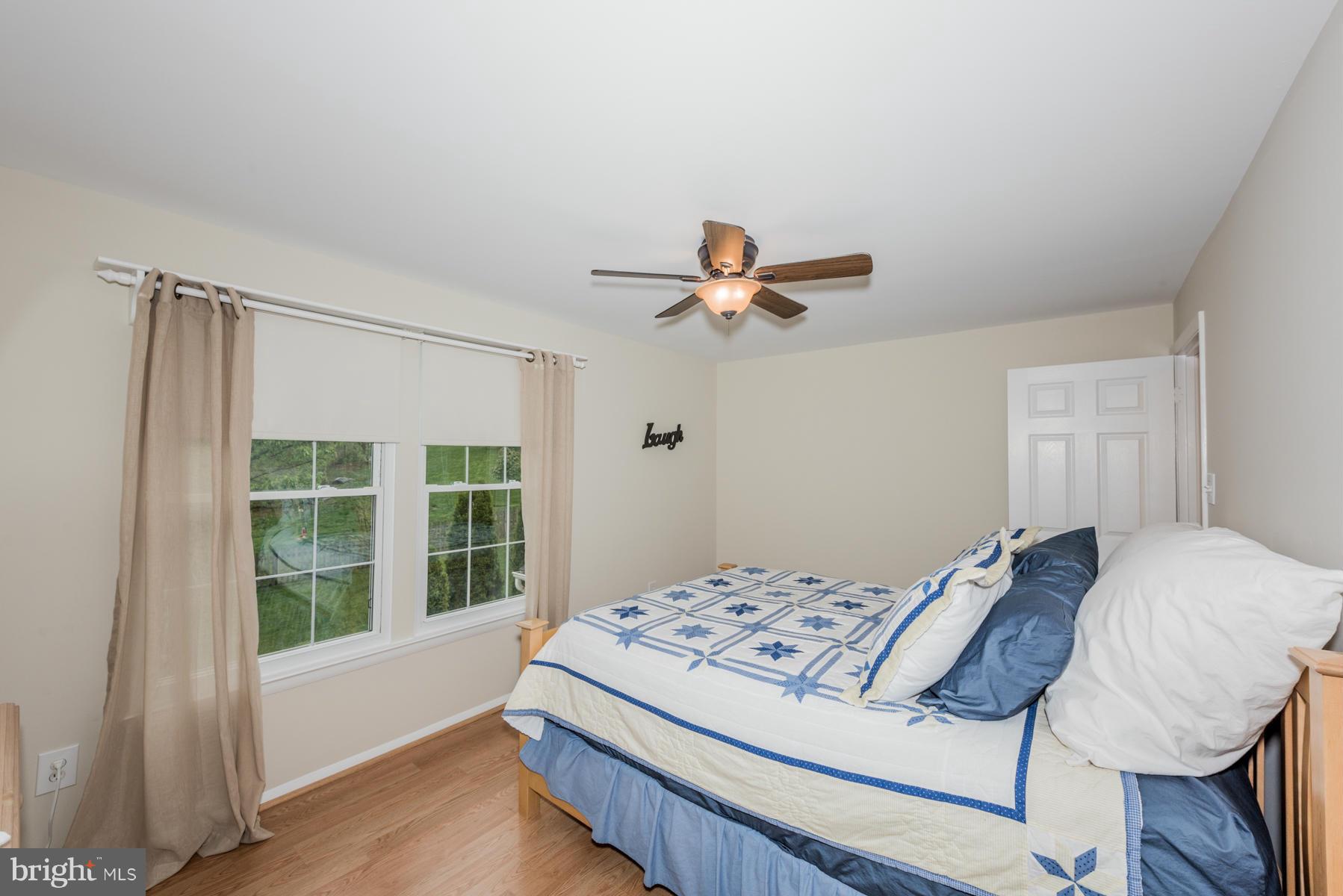 6032 Bakers Place Hanover, MD 21076 - Photo 21 of 30 a living room with a bed furniture and a window