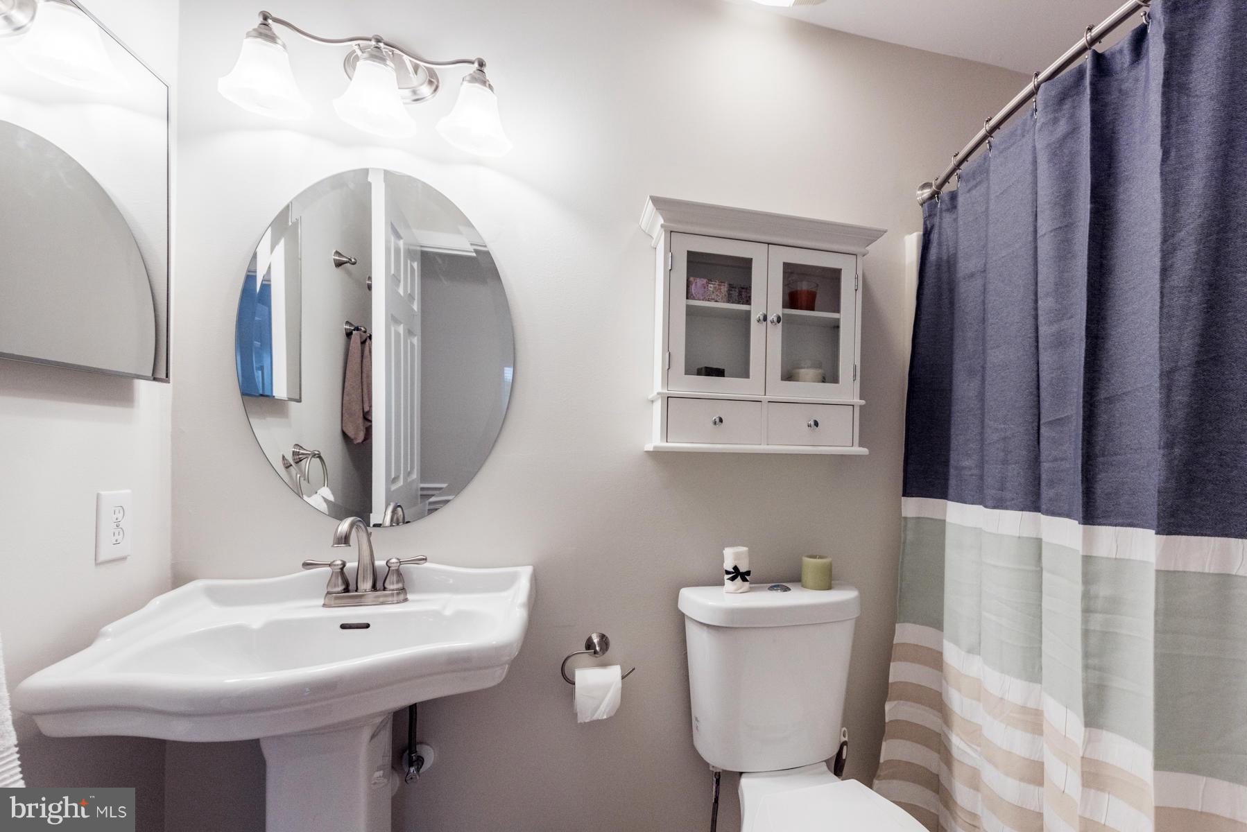 6032 Bakers Place Hanover, MD 21076 - Photo 23 of 30 a bathroom with a sink a toilet and mirror