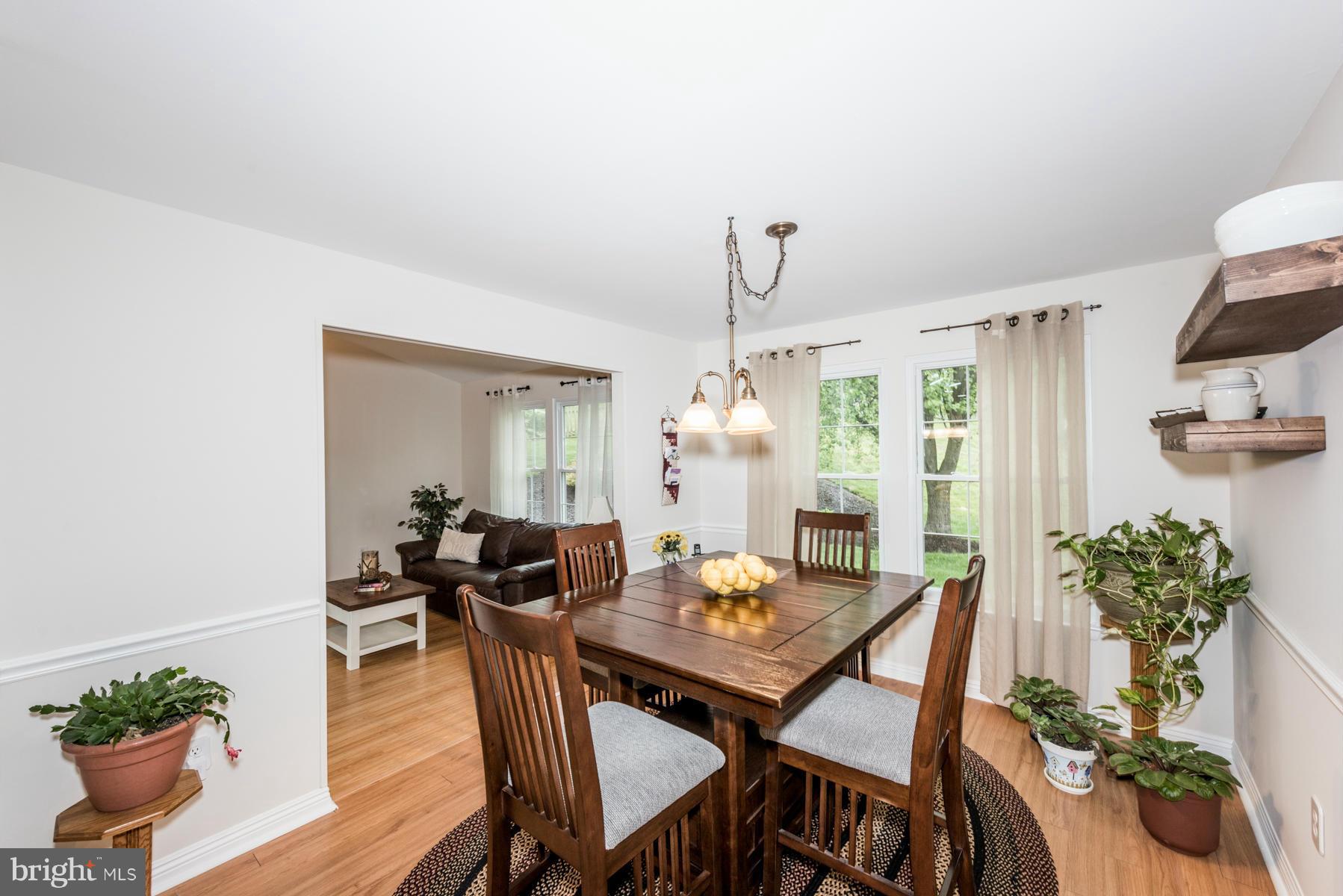 6032 Bakers Place Hanover, MD 21076 - Photo 6 of 30 a view of a dining room with furniture window and wooden floor