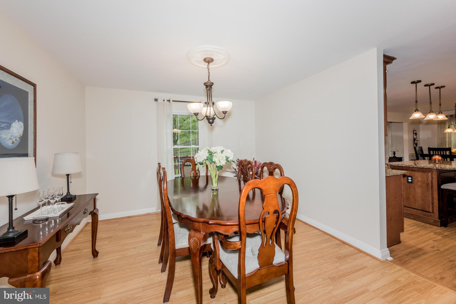 6032 Bakers Place Hanover, MD 21076 - Photo 8 of 30 a view of a dining room with furniture and wooden floor