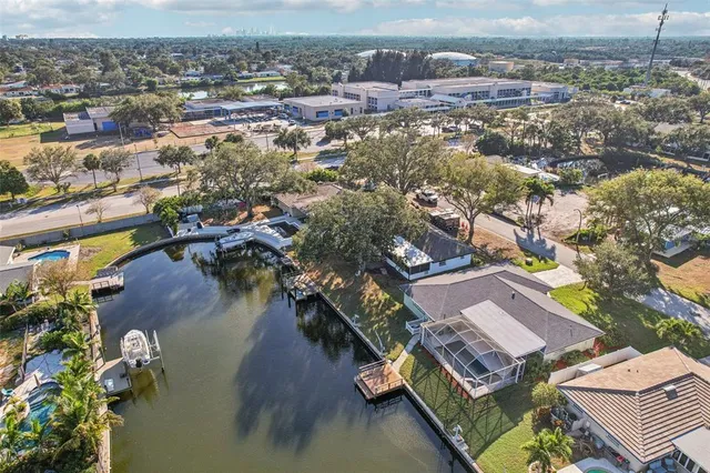an aerial view of residential houses with outdoor space and lake view