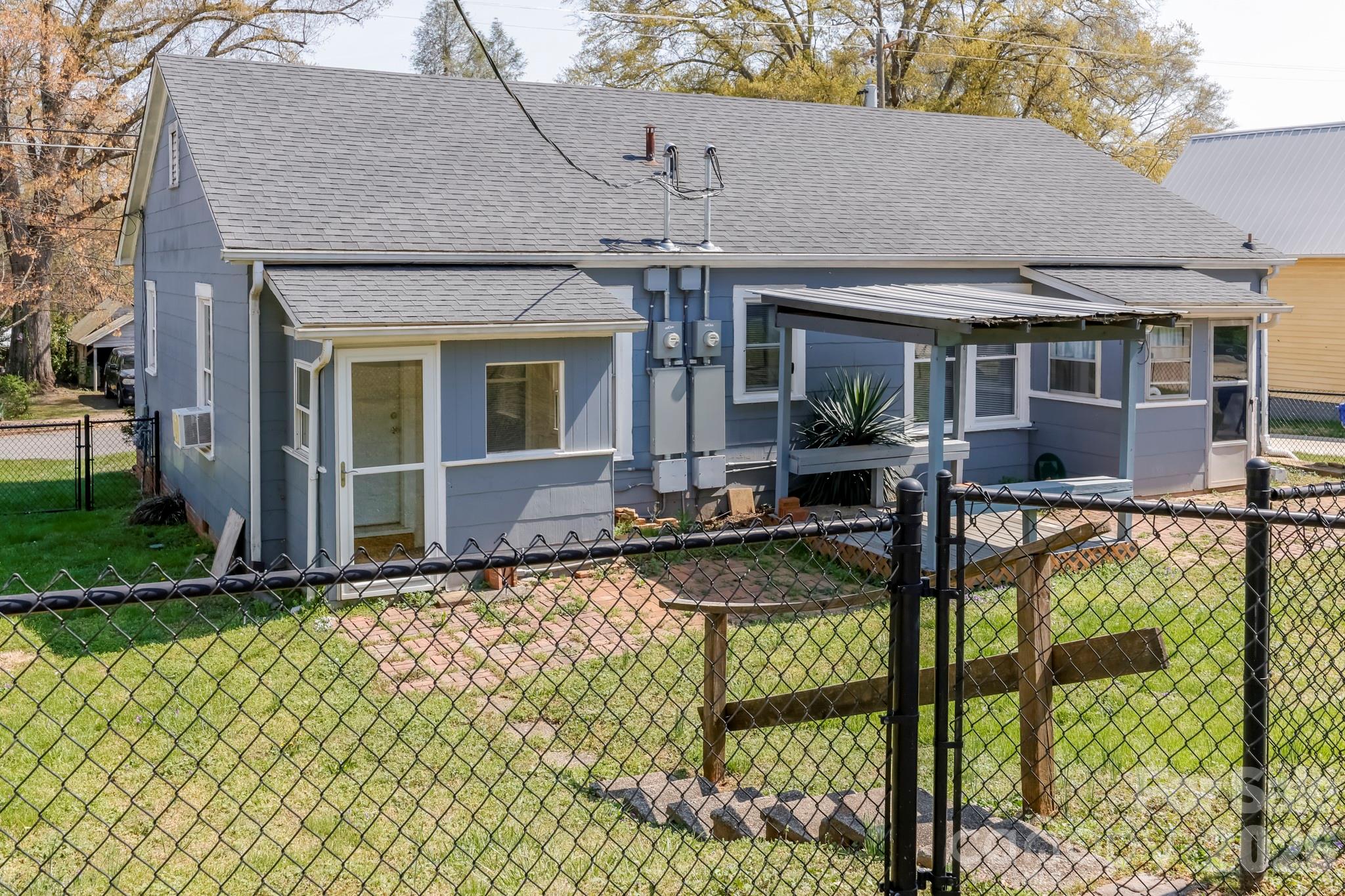 114 South Mitchell Avenue Rutherfordton, NC 28139 - Photo 12 of 29 front view of house with large windows and a table