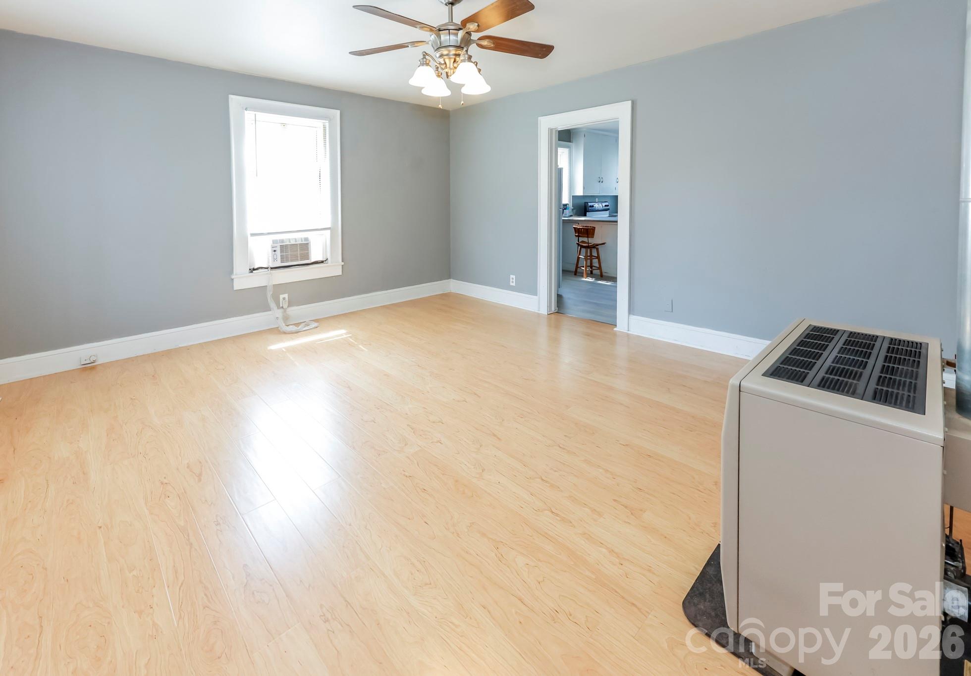 114 South Mitchell Avenue Rutherfordton, NC 28139 - Photo 13 of 29 a view of an empty room with window and wooden floor