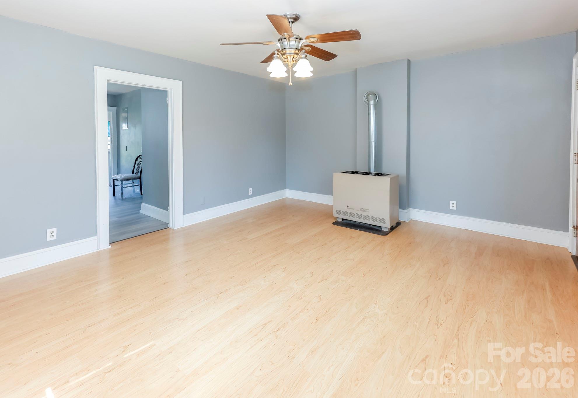 114 South Mitchell Avenue Rutherfordton, NC 28139 - Photo 14 of 29 an empty room with chandelier fan and windows