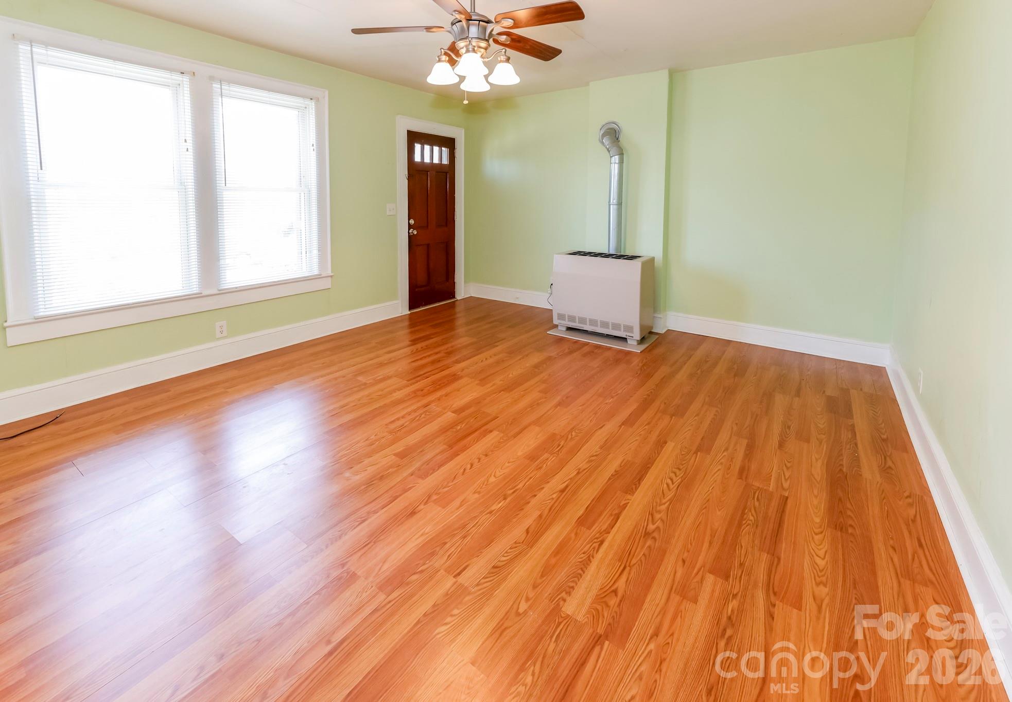 114 South Mitchell Avenue Rutherfordton, NC 28139 - Photo 22 of 29 a view of an empty room with wooden floor and a window