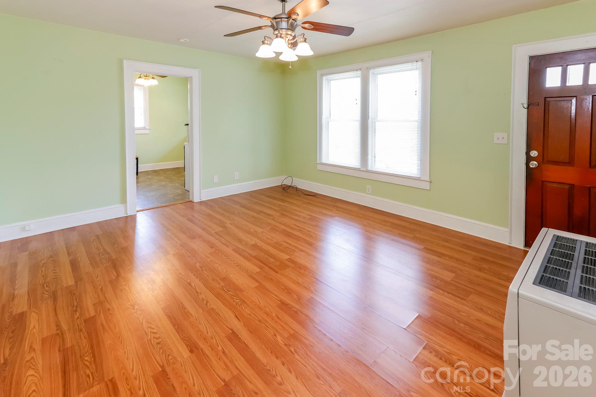 114 South Mitchell Avenue Rutherfordton, NC 28139 - Photo 23 of 29 a view of empty room with wooden floor and fan