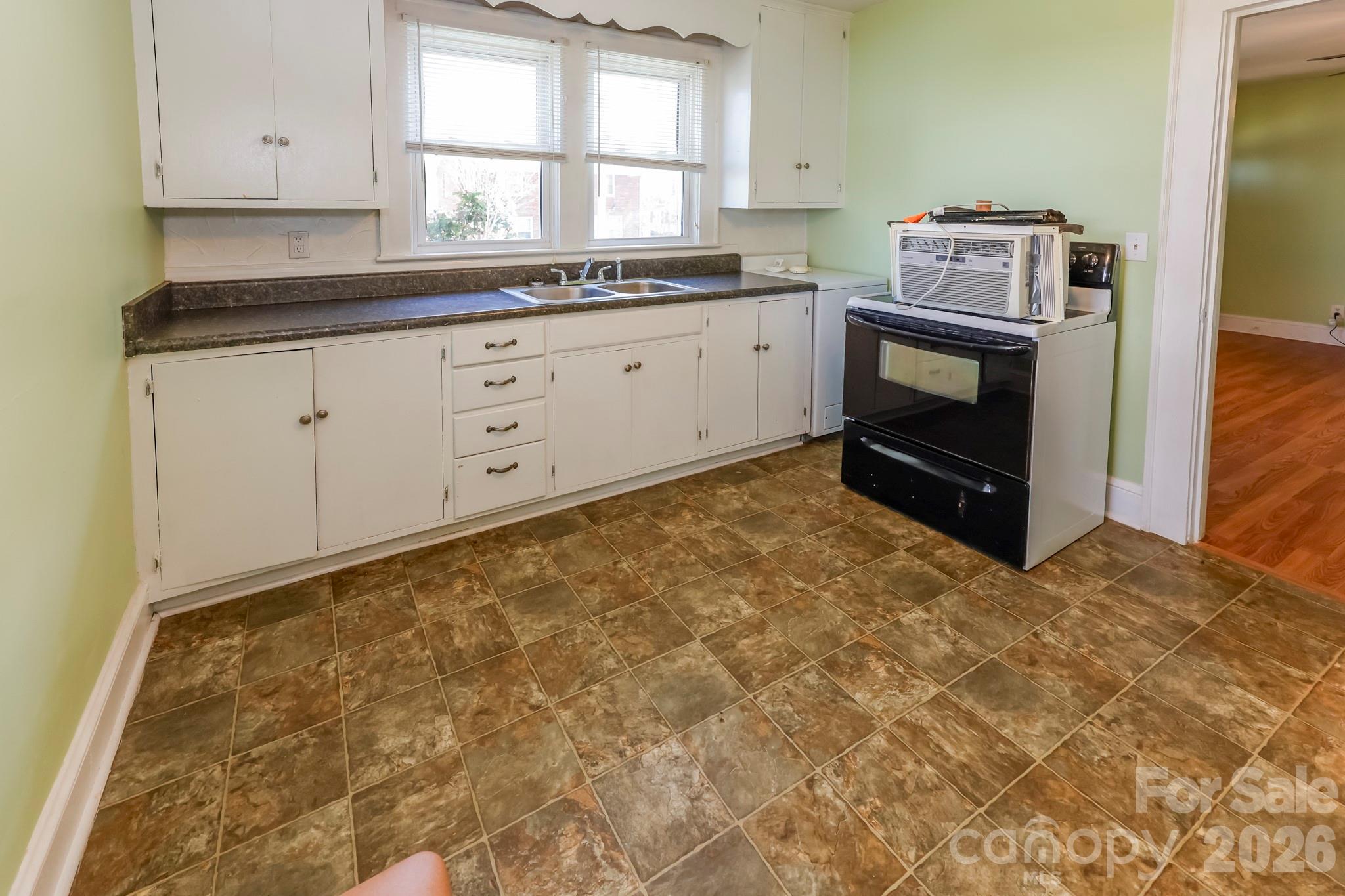 114 South Mitchell Avenue Rutherfordton, NC 28139 - Photo 24 of 29 a utility room with granite countertop cabinets washer and dryer