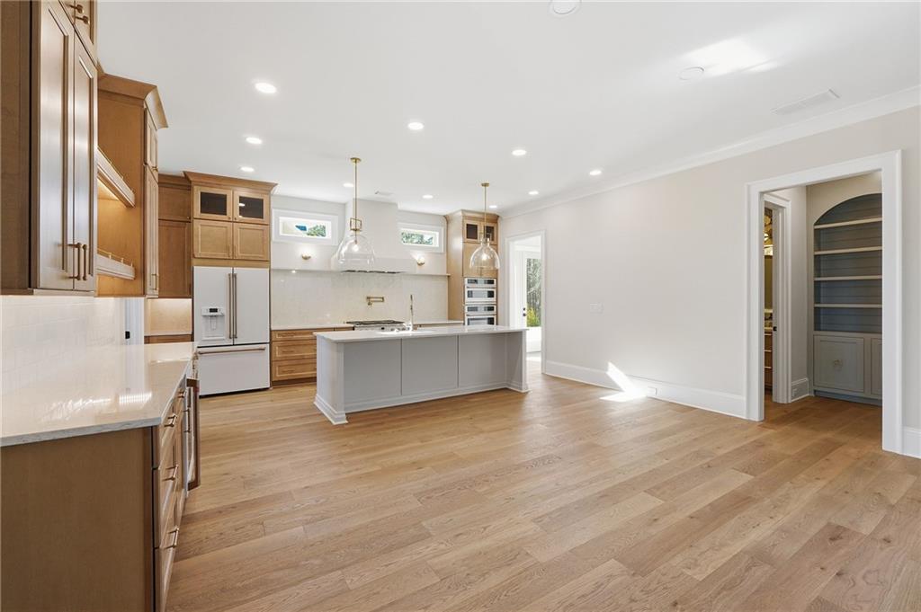 280 County Road Southwest Marietta, GA 30064 - Photo 11 of 40 a large kitchen with stainless steel appliances granite countertop a large counter top and a wooden floors