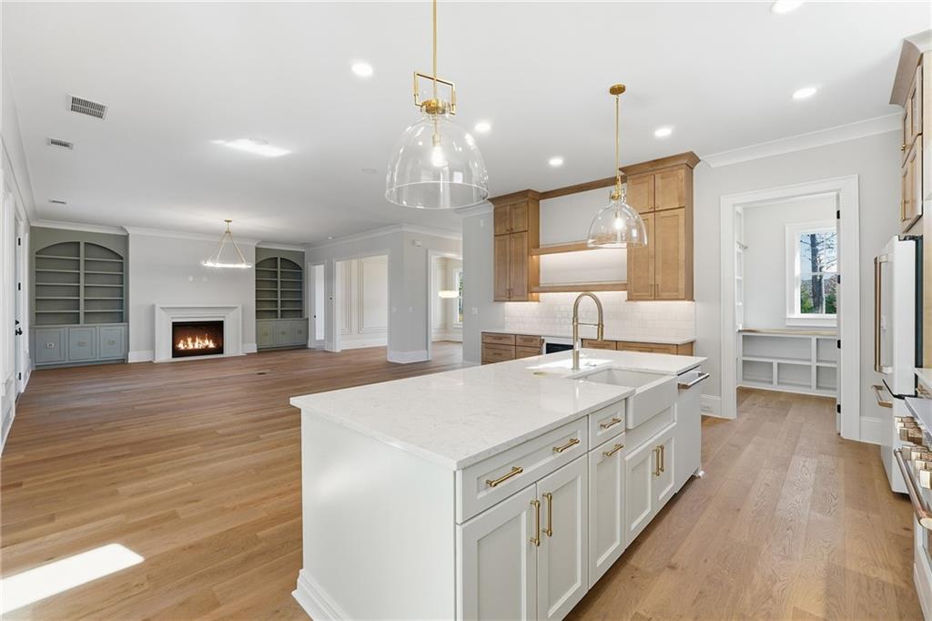280 County Road Southwest Marietta, GA 30064 - Photo 15 of 40 a large kitchen with kitchen island a stove a sink a refrigerator and a fireplace