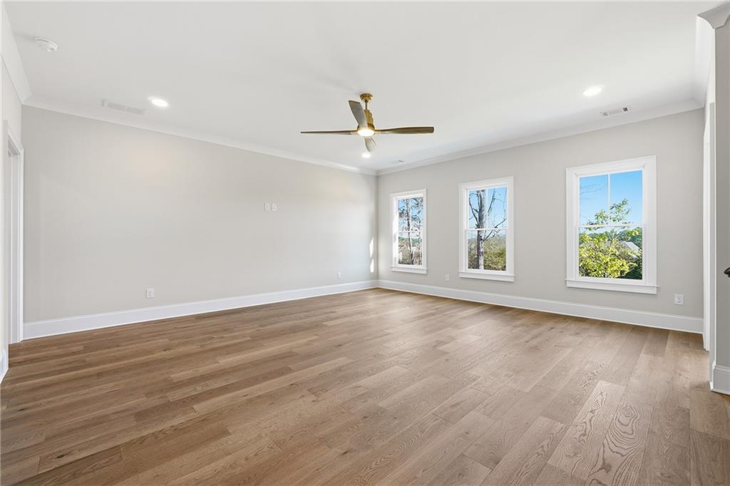 280 County Road Southwest Marietta, GA 30064 - Photo 28 of 40 an empty room with wooden floor ceiling fan and windows