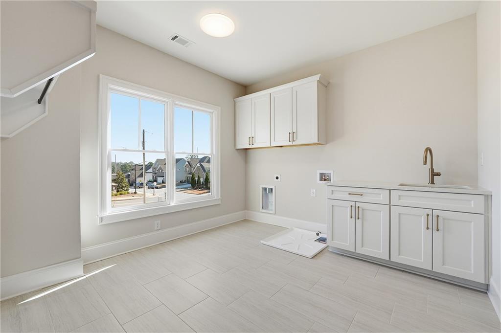 280 County Road Southwest Marietta, GA 30064 - Photo 35 of 40 a kitchen with white cabinets and window