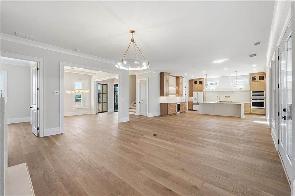 280 County Road Southwest Marietta, GA 30064 - Photo 9 of 40 a view of a room with wooden floor and a kitchen