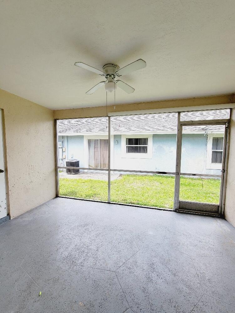 12785 Peconic Court, Unit 12785 Wellington, FL 33414 - Photo 2 of 12 a view of an empty room with a window