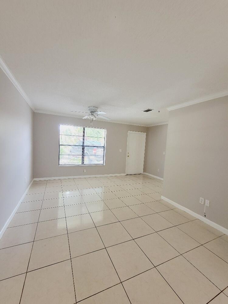 12785 Peconic Court, Unit 12785 Wellington, FL 33414 - Photo 6 of 12 a view of an empty room with a window