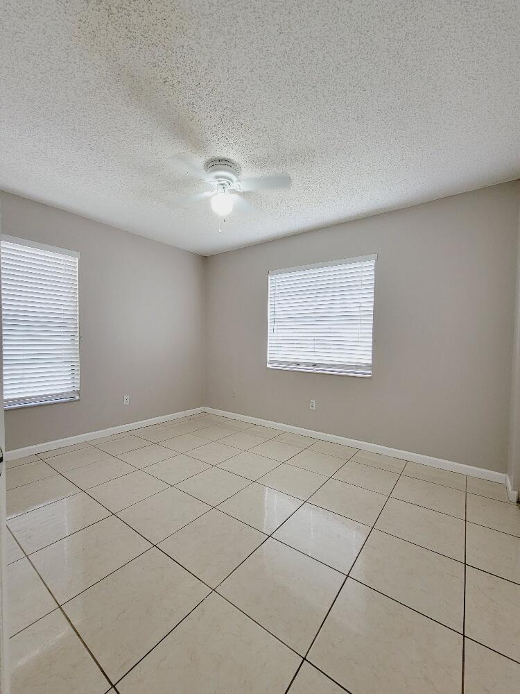 12785 Peconic Court, Unit 12785 Wellington, FL 33414 - Photo 7 of 12 a view of an empty room and a window