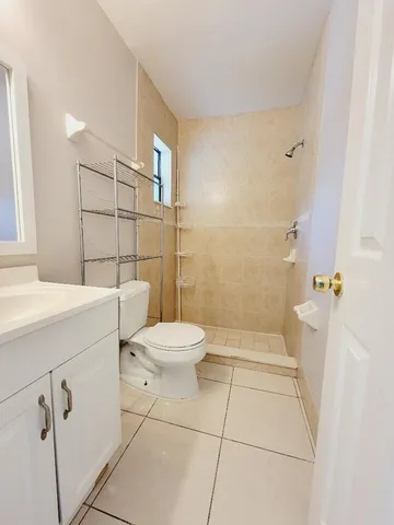 a bathroom with a toilet sink and shower