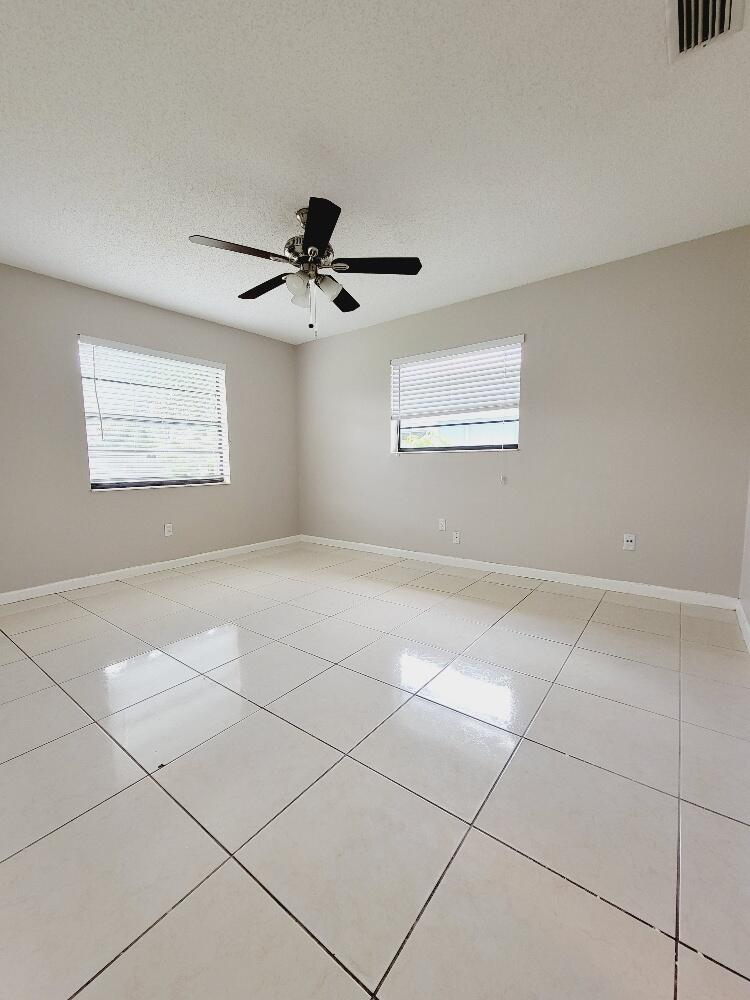 12785 Peconic Court, Unit 12785 Wellington, FL 33414 - Photo 9 of 12 a view of an empty room with a window