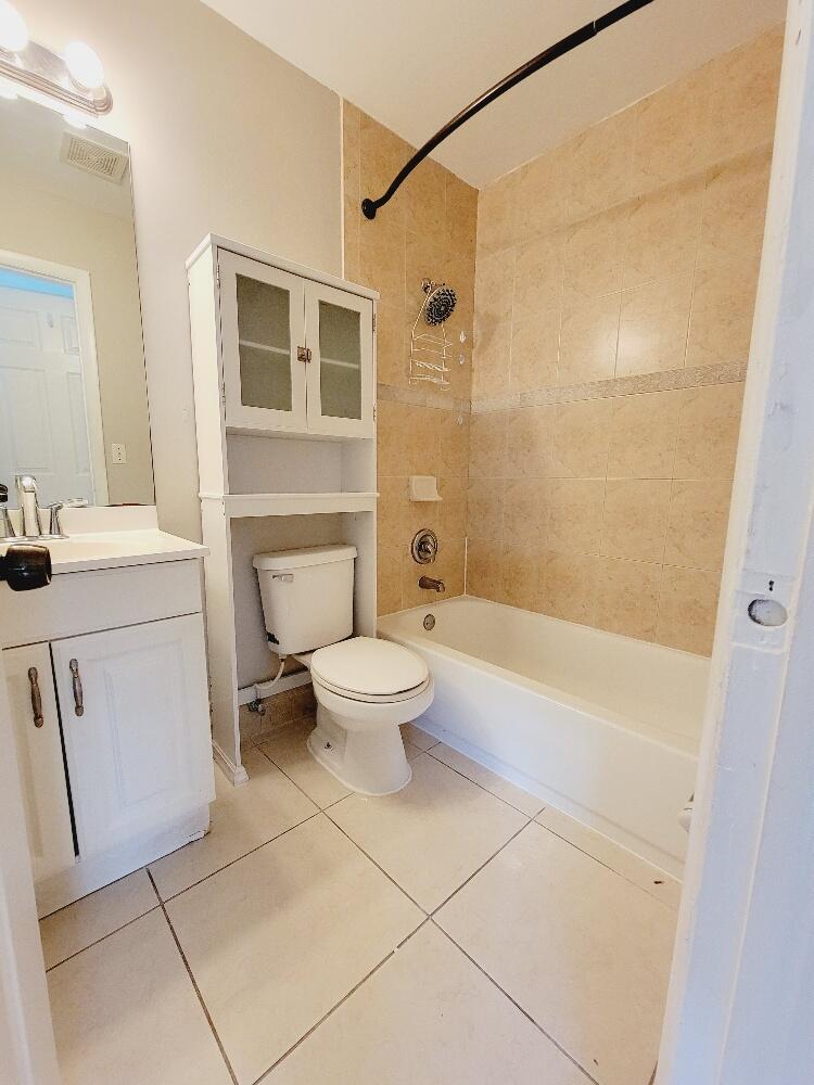 12785 Peconic Court, Unit 12785 Wellington, FL 33414 - Photo 10 of 12 a bathroom with a sink a toilet and shower