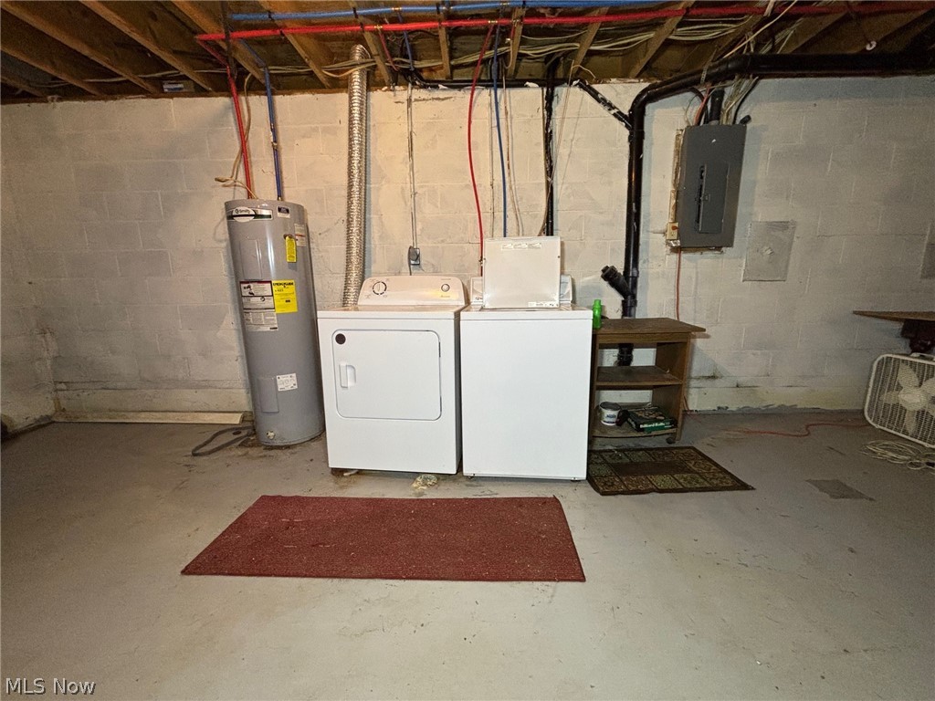 57575 Marietta Road Byesville, OH 43723 - Photo 19 of 25 Utility area featuring a water heater, washer, and dryer units