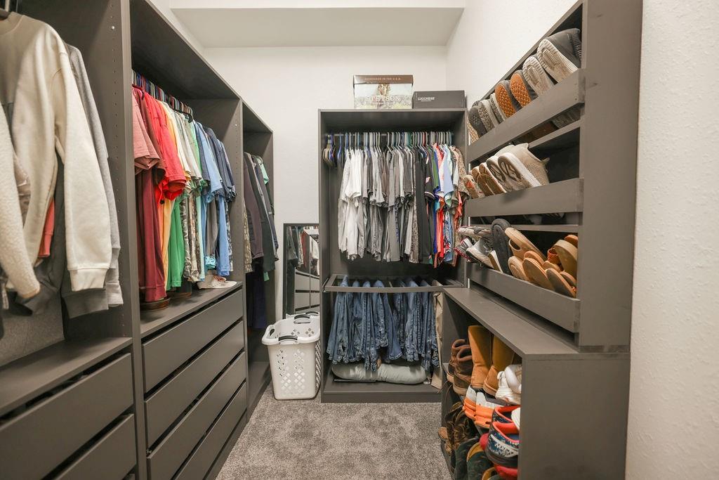 9501 Oakwood Road Quinlan, TX 75474 - Photo 15 of 34 a view of walk in closet with clothes and shoes