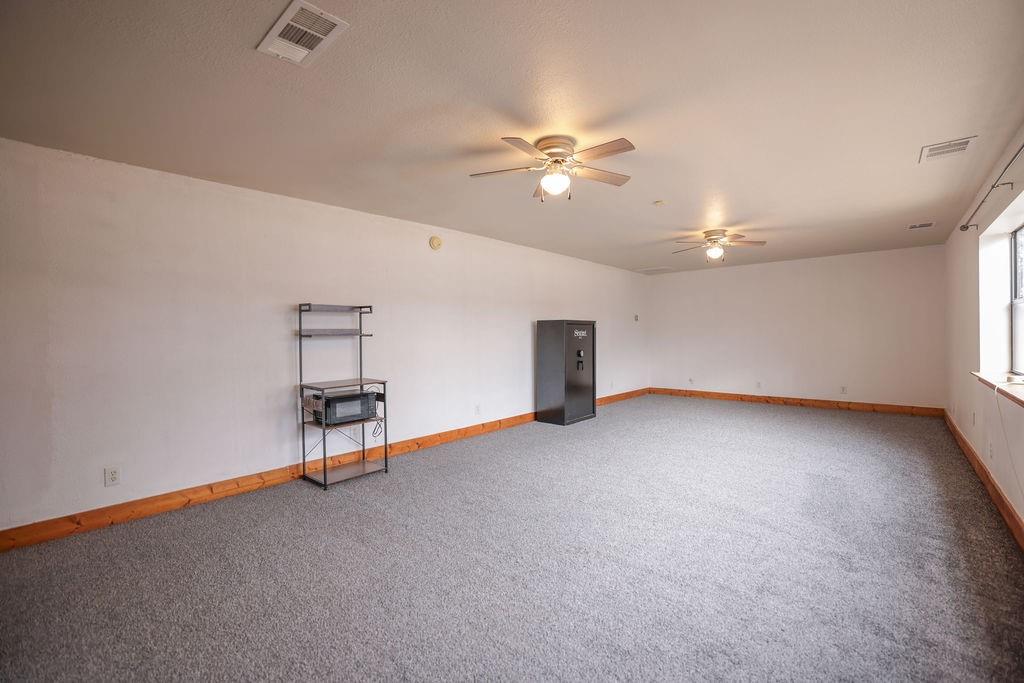9501 Oakwood Road Quinlan, TX 75474 - Photo 20 of 34 wooden floor in an empty room with a window