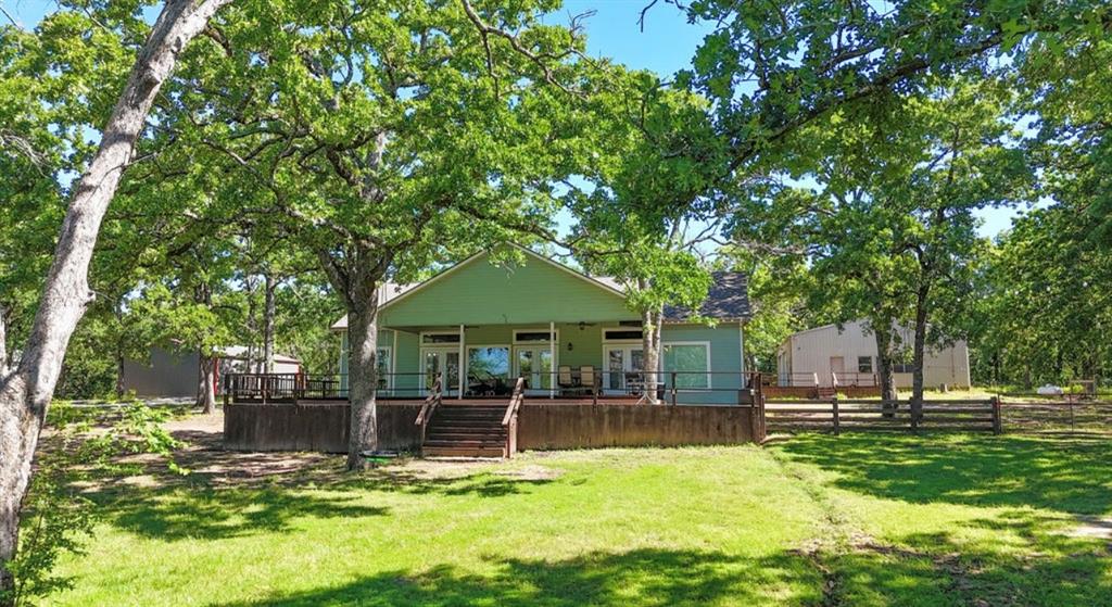 9501 Oakwood Road Quinlan, TX 75474 - Photo 2 of 34 a view of a house with backyard and sitting area