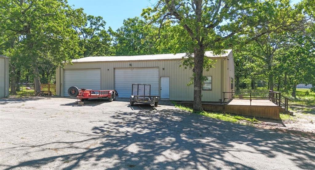 9501 Oakwood Road Quinlan, TX 75474 - Photo 24 of 34 a view of a backyard with a large tree
