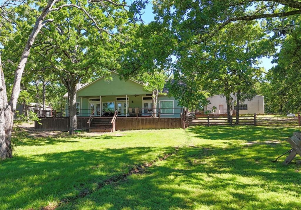 9501 Oakwood Road Quinlan, TX 75474 - Photo 26 of 34 a swimming pool with outdoor seating and yard
