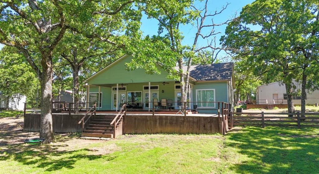 9501 Oakwood Road Quinlan, TX 75474 - Photo 28 of 34 a view of a house with swimming pool and sitting area