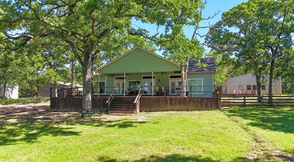 9501 Oakwood Road Quinlan, TX 75474 - Photo 29 of 34 a front view of a house with a garden