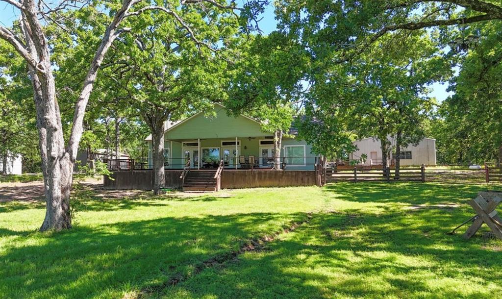 9501 Oakwood Road Quinlan, TX 75474 - Photo 31 of 34 a view of a house with a yard porch and sitting area