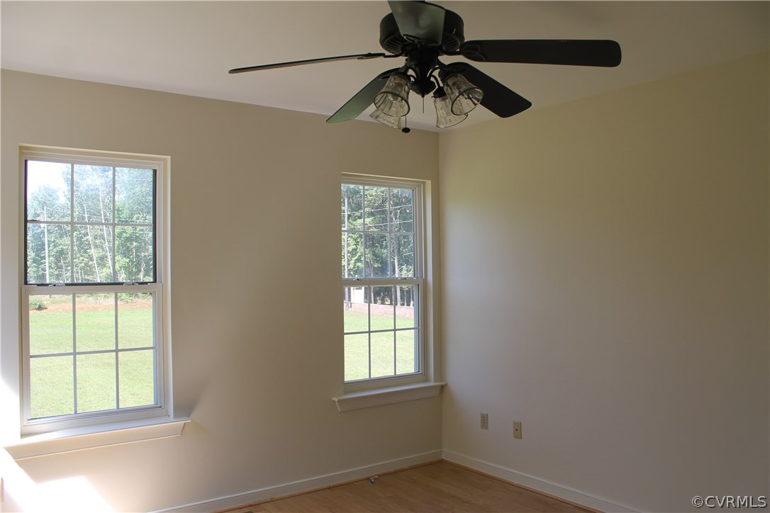 329 Mallory Road Louisa, VA 23093 - Photo 4 of 12 an empty room with a window and a fan