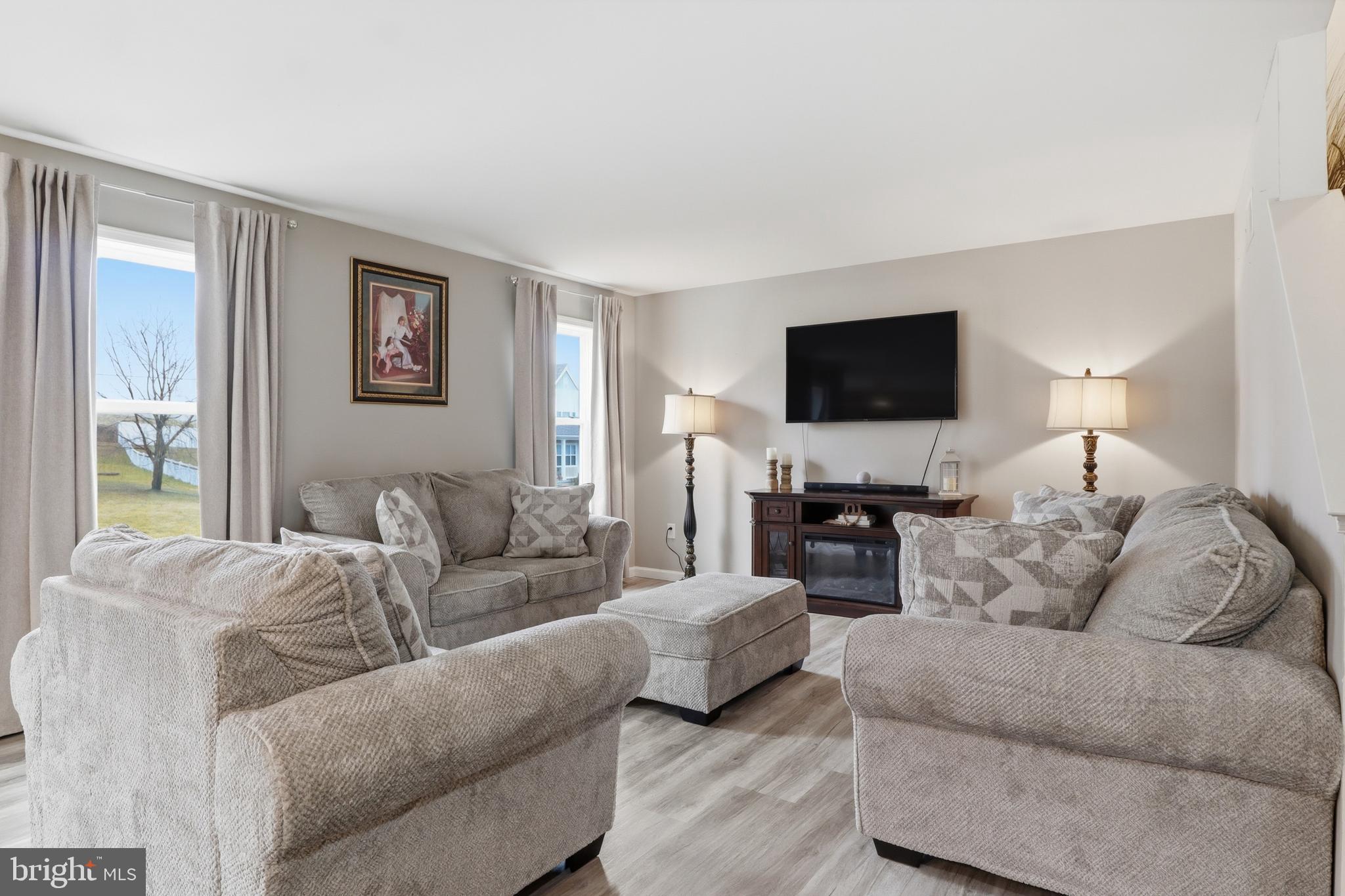 99 McIntosh Lane Aspers, PA 17304 - Photo 18 of 63 a living room with furniture a flat screen tv and a fireplace
