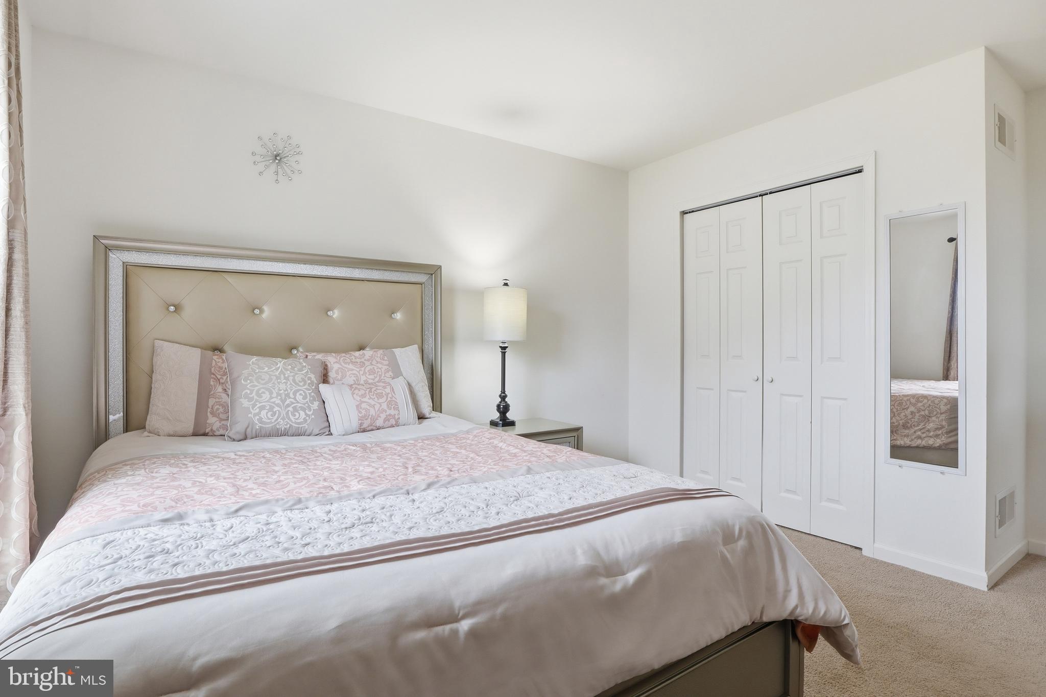 99 McIntosh Lane Aspers, PA 17304 - Photo 28 of 63 a bedroom with a large bed and a chandelier