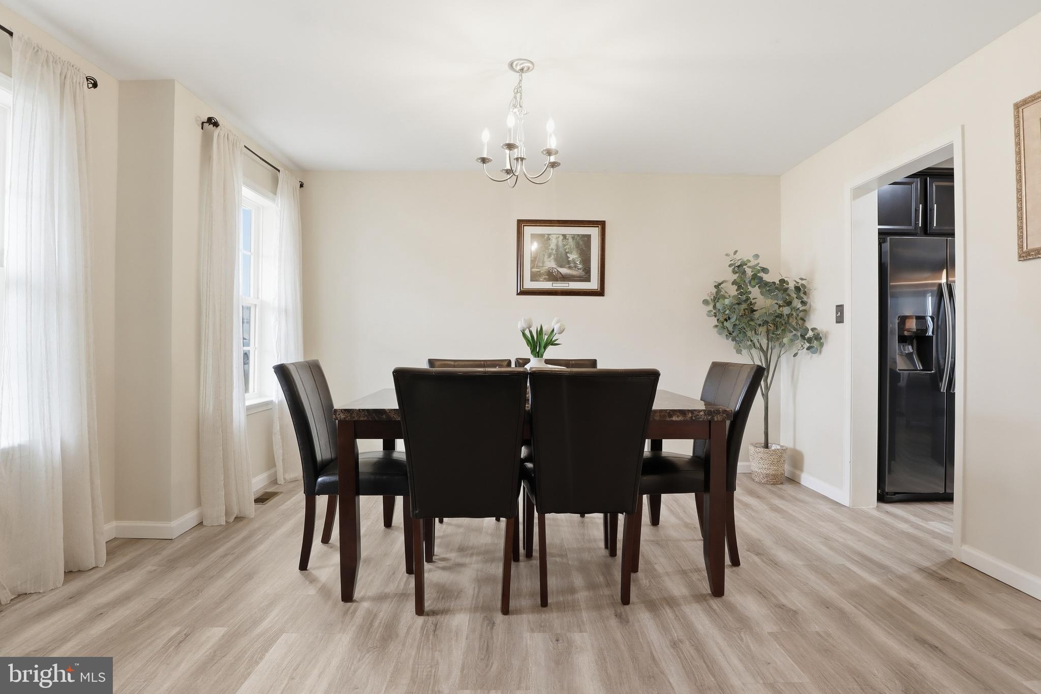 99 McIntosh Lane Aspers, PA 17304 - Photo 8 of 63 a view of a dining room with furniture wooden floor and a chandelier