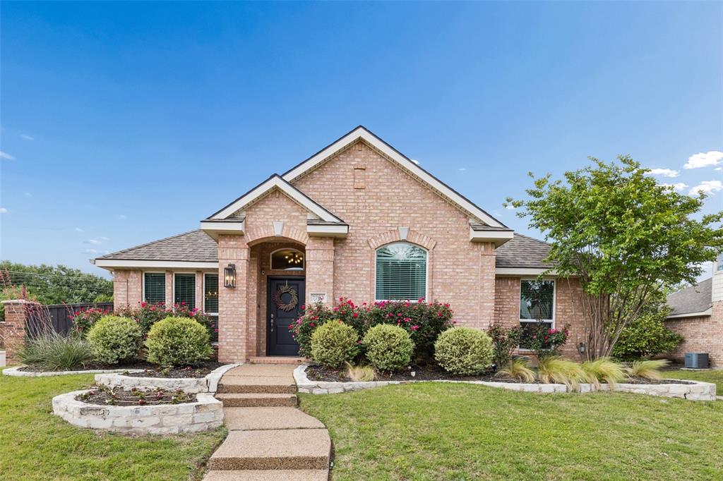 7703 Worthing Street Dallas, TX 75252 - Photo 1 of 21 a front view of a house with a yard and garage