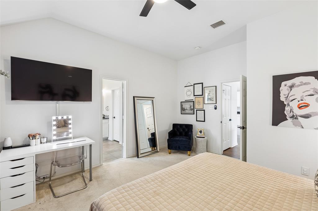 7703 Worthing Street Dallas, TX 75252 - Photo 12 of 21 a bedroom with a bed and a flat screen tv