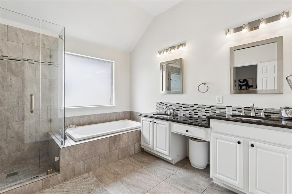 7703 Worthing Street Dallas, TX 75252 - Photo 13 of 21 a bathroom with a granite countertop bathtub sink vanity and mirror