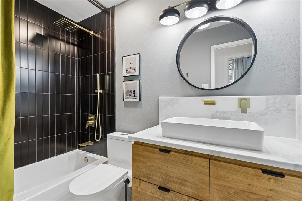7703 Worthing Street Dallas, TX 75252 - Photo 15 of 21 a bathroom with a sink toilet and shower