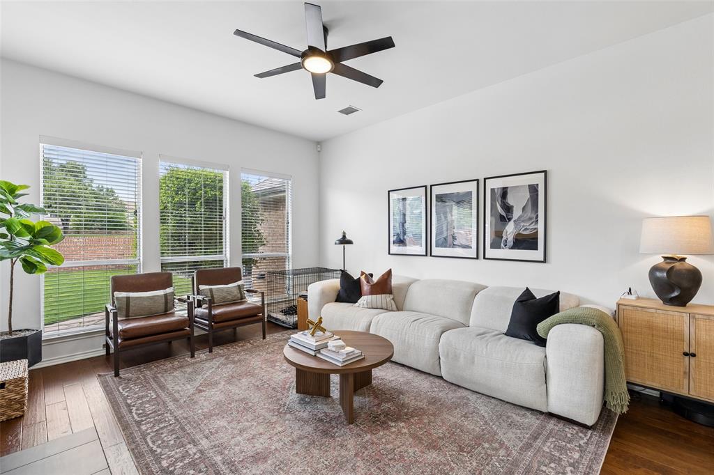7703 Worthing Street Dallas, TX 75252 - Photo 7 of 21 a living room with furniture ceiling fan and a rug