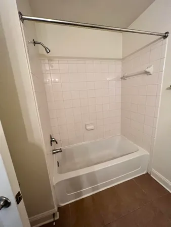 a bathroom with a shower and a bath tub