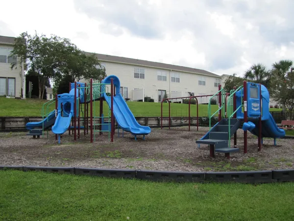 a view of outdoor space with playground and green space