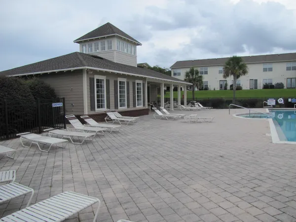 a front view of house with yard outdoor seating and barbeque oven